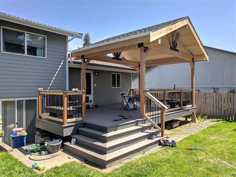 adding a patio to house with metal roof|extending a roof over deck.